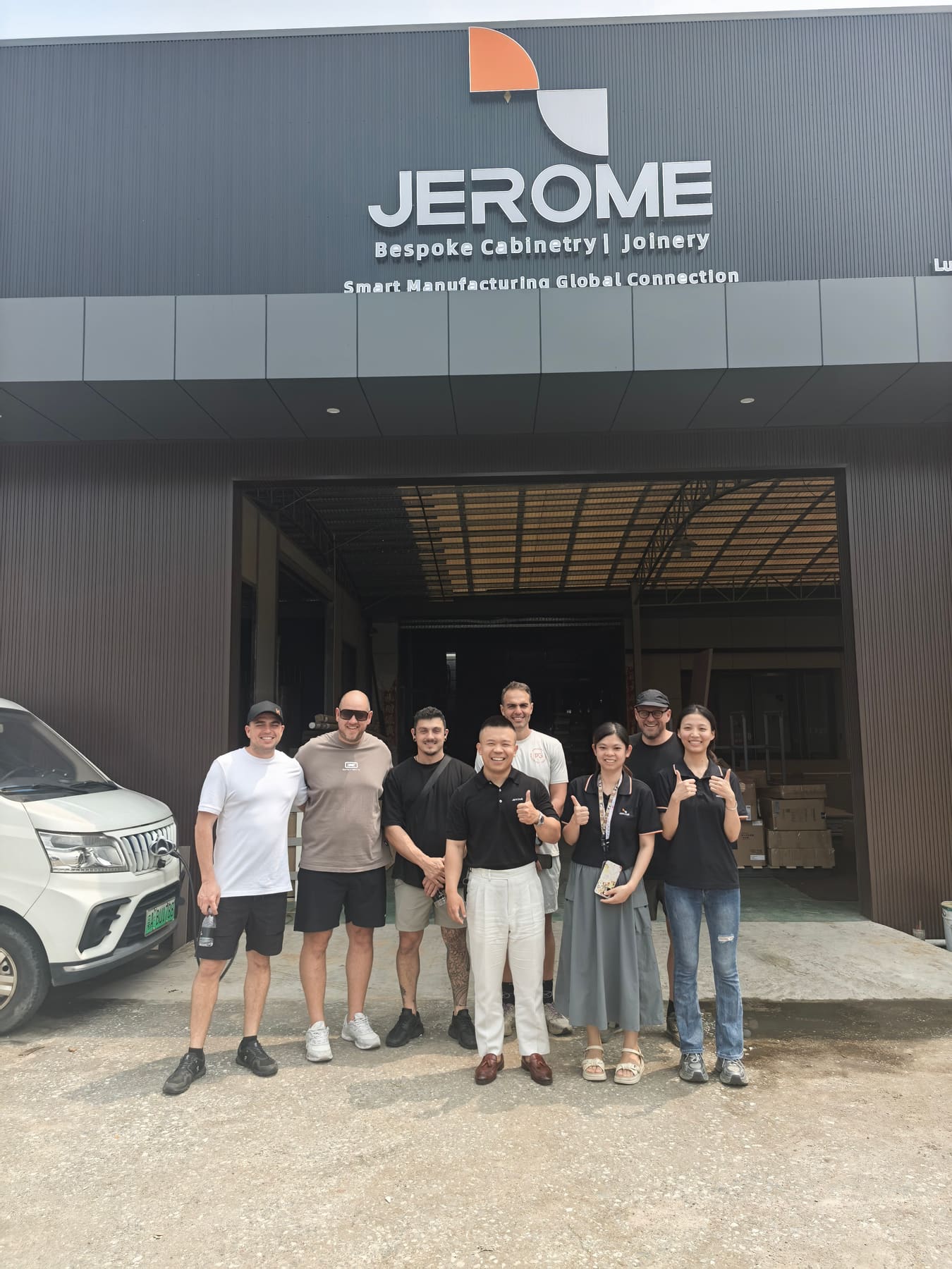 Visitors and the Jerome team together outside the Jerome manufacturing building