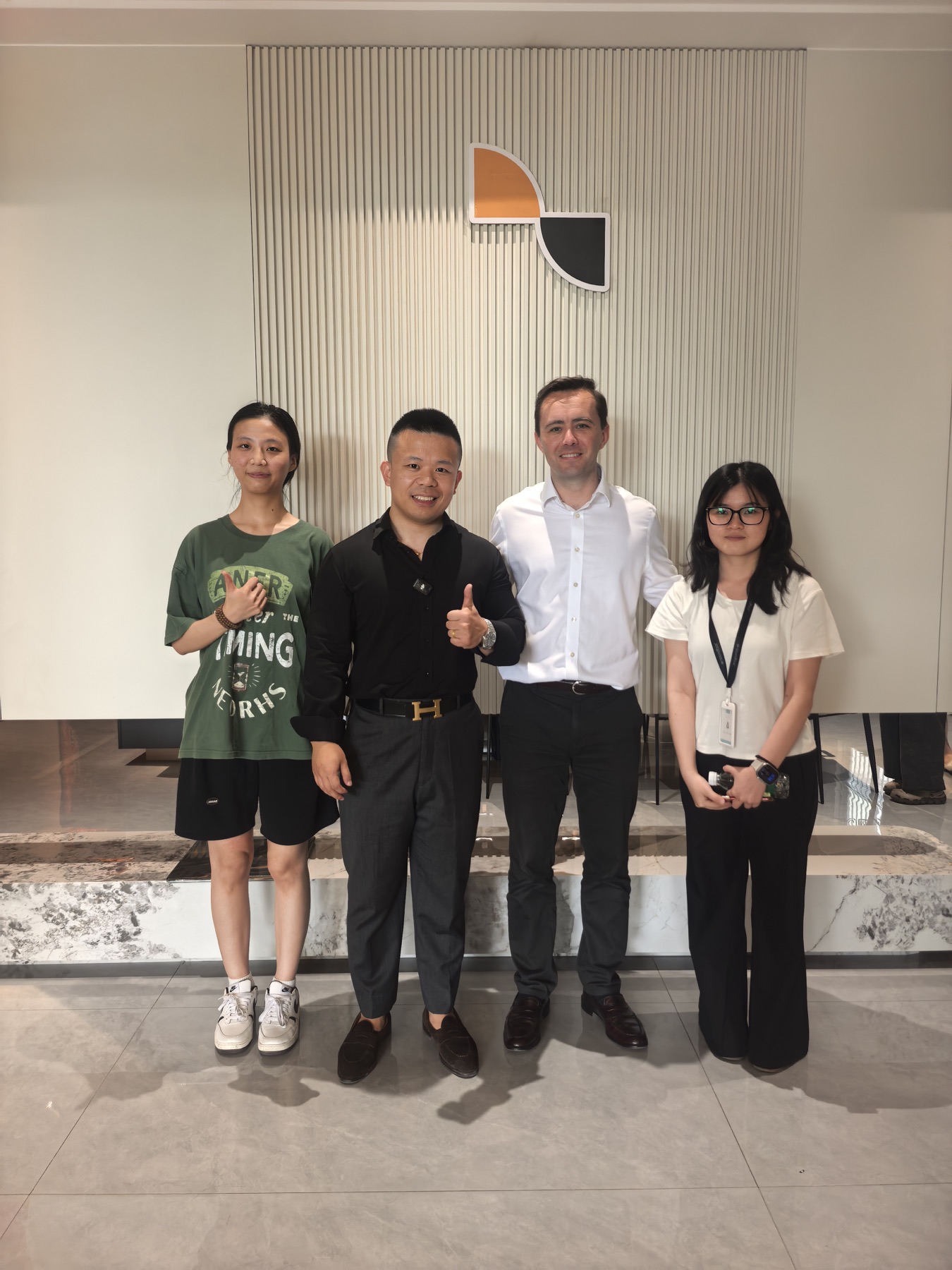 Visitors photographed with a Jerome team member in the showroom